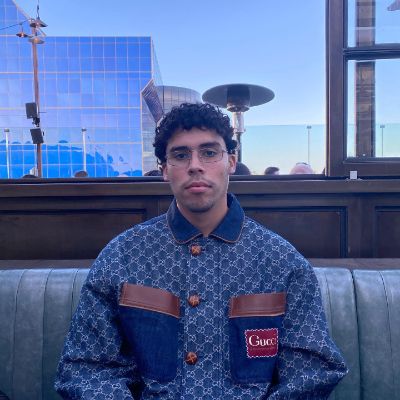 Bernie Martinez Ocasio wearing a GUCCI jacket and taking a photo on the rooftop.